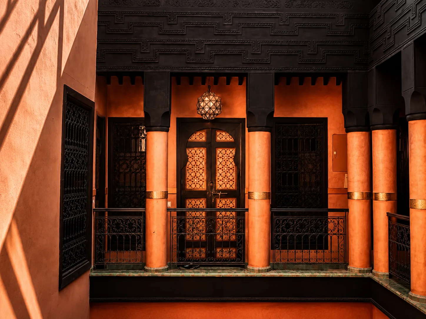 Inside the riad — carved cedar, columns and a lantern